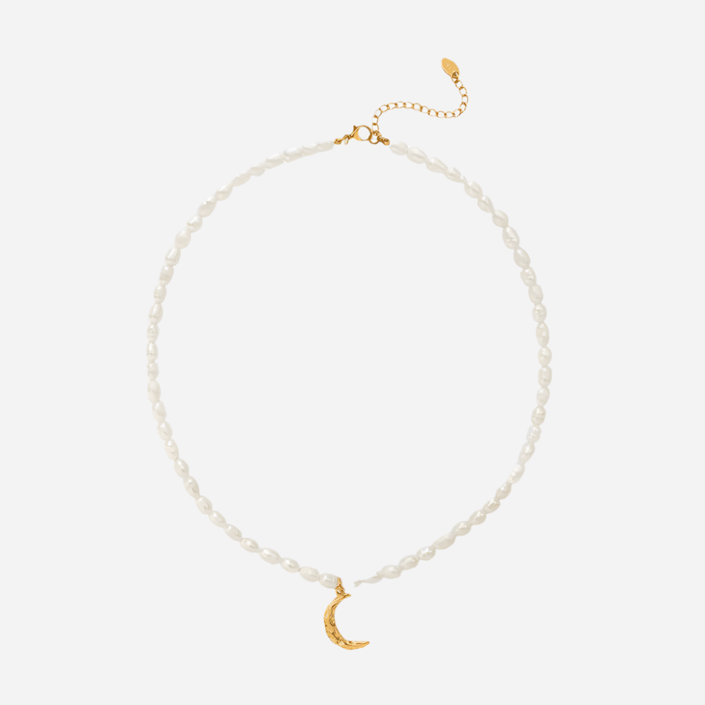 Pearl necklace with a gold crescent moon pendant on a white background