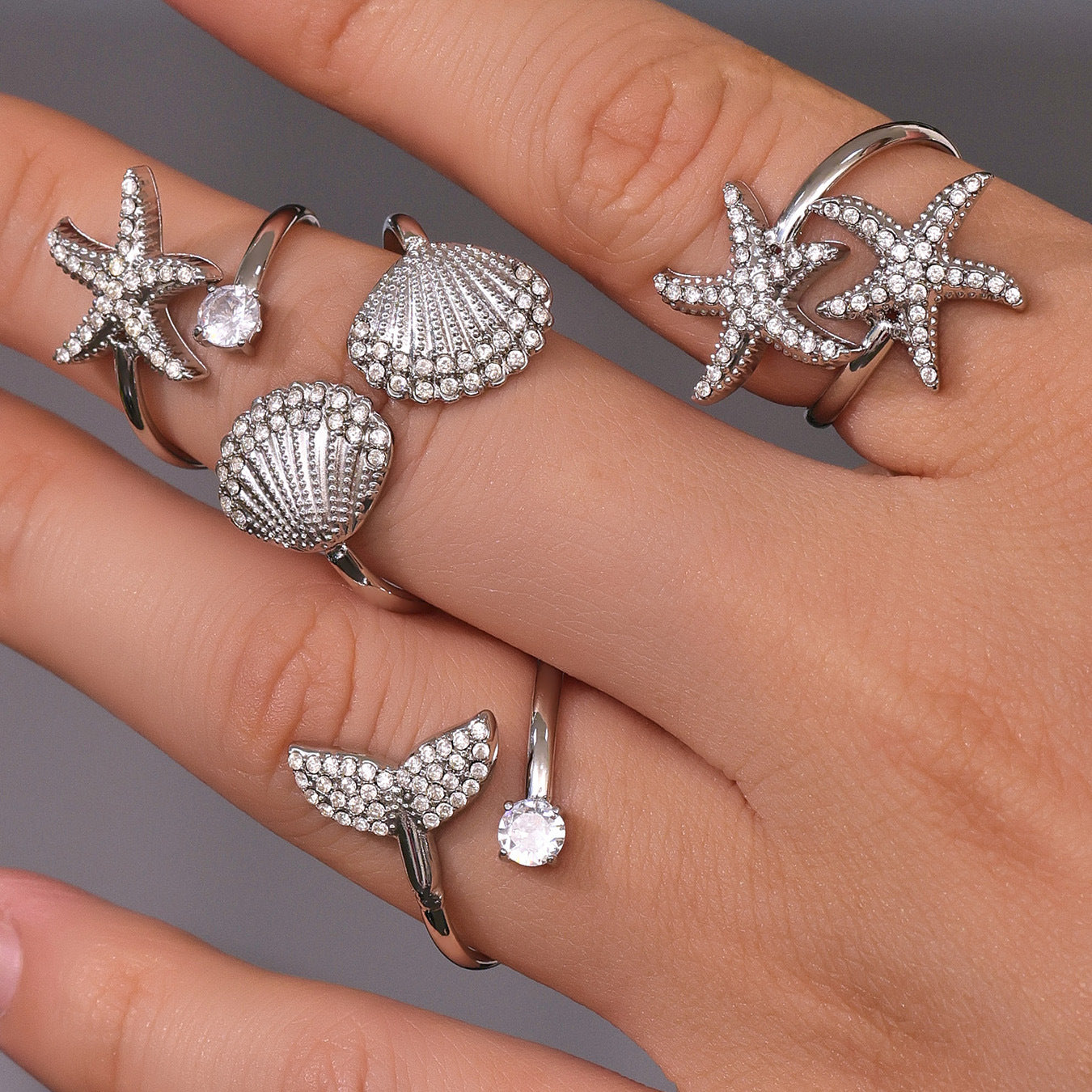 Layered stacking style with starfish star ring and other gold rings, adjustable open band design