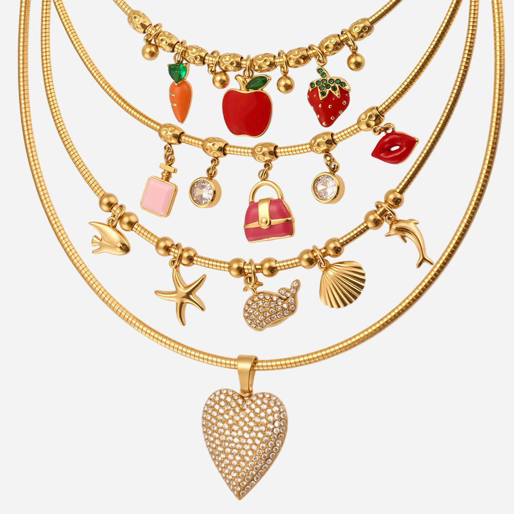 Gold necklaces with various charms on a white background
