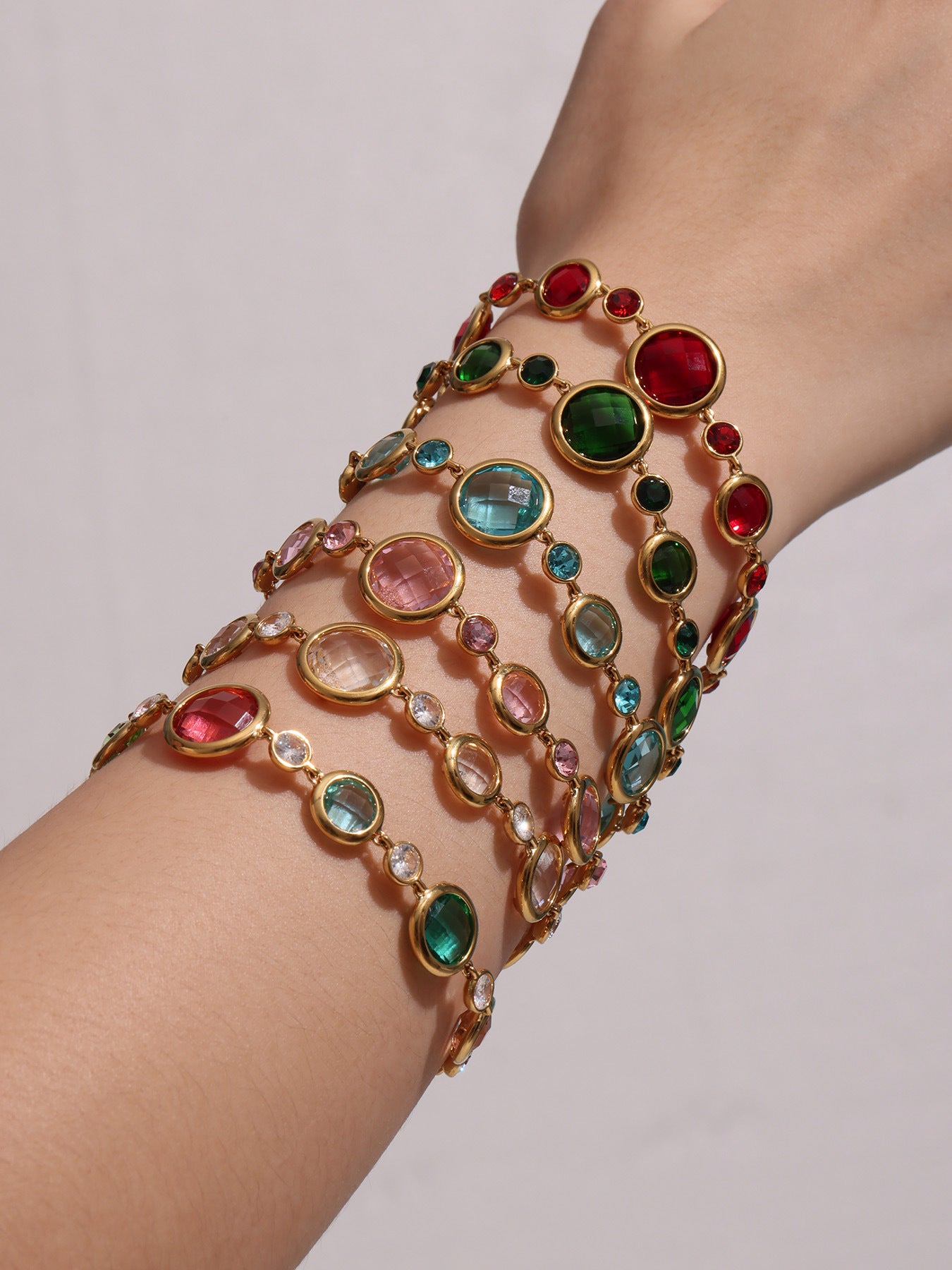Side view of model arm wearing stacked Czech glass bracelets


