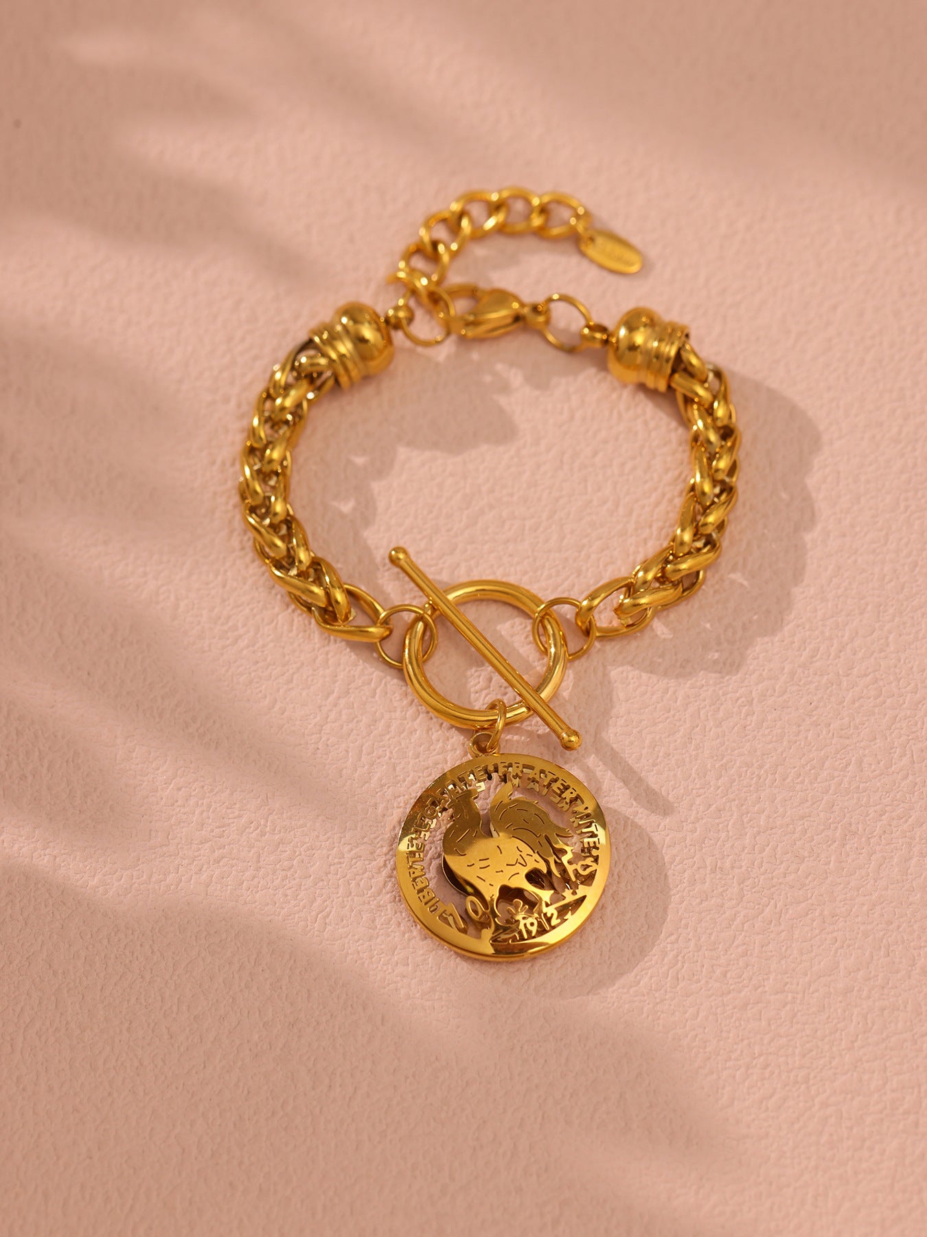 Urban stainless steel gold curb chain bracelet on wooden table

