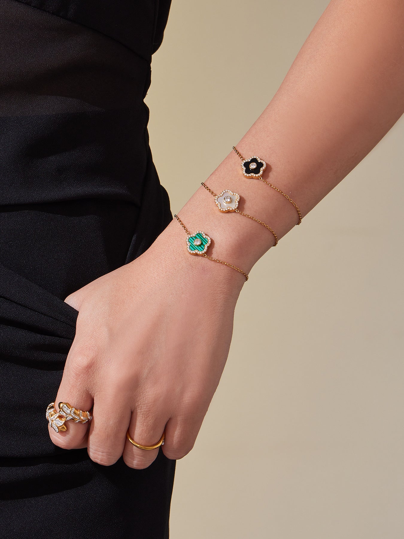 Jewelry set with bracelets and rings on a neutral background